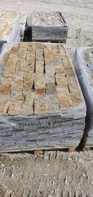 Pallet of rock-face gneiss cladding pieces wrapped for shipment